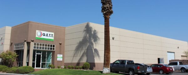 A building with a tall palm tree.
