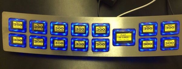 A metal Ainsworth Button Panel GETT Part BP112 with blue led lights on it.