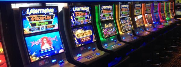 A row of 23" Aristocrat Helix Touch Sensor TOVIS (PCT) TOUCH SCREEN slot machines in a casino.