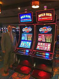 A man standing in front of a Bally Wave IDeck Touch Sensor, Bezel Frame TES# 237413. GETT Part 3241 in a casino.