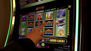A man is playing a 20.27" Touch Sensor, Part 3106C. InoTouch #C208N32AG20-01C in a casino.