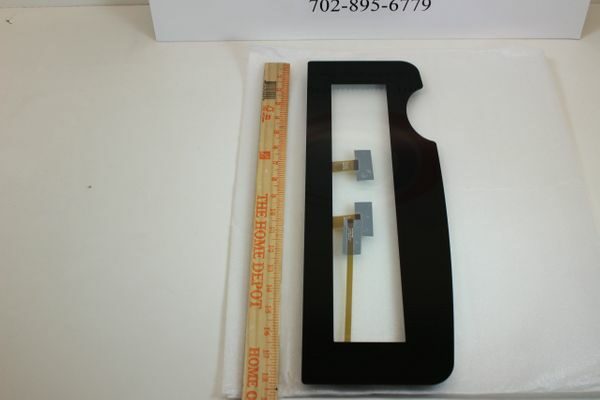 A black piece of plastic with a ruler next to it.