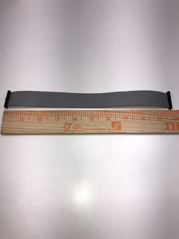 A measuring tape with a ruler next to it. Cable for Bill Validator BV175. See Photo.