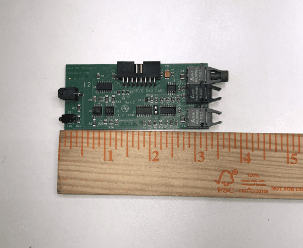 An IGT AVP Fiber Optic Comm. Board next to a ruler.