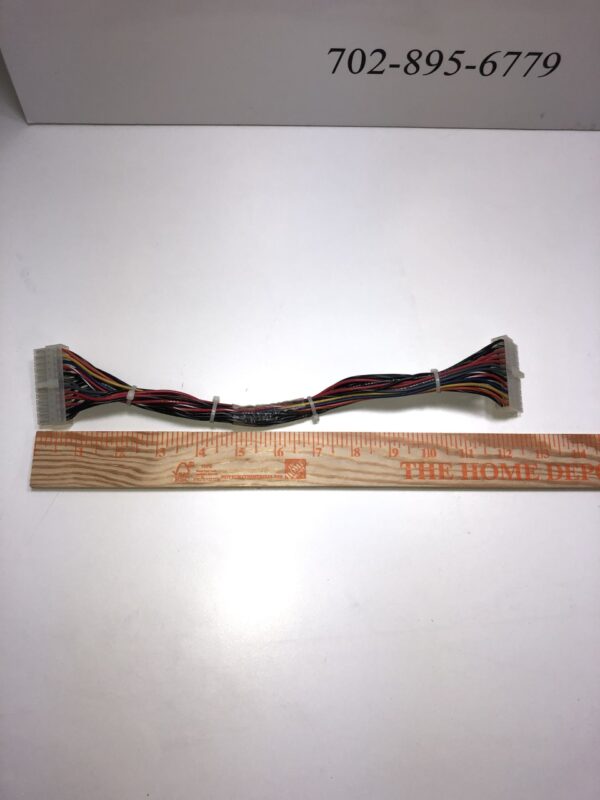 A piece of JCM Cable for WBA and UBA Bill acceptor with a ruler next to it.