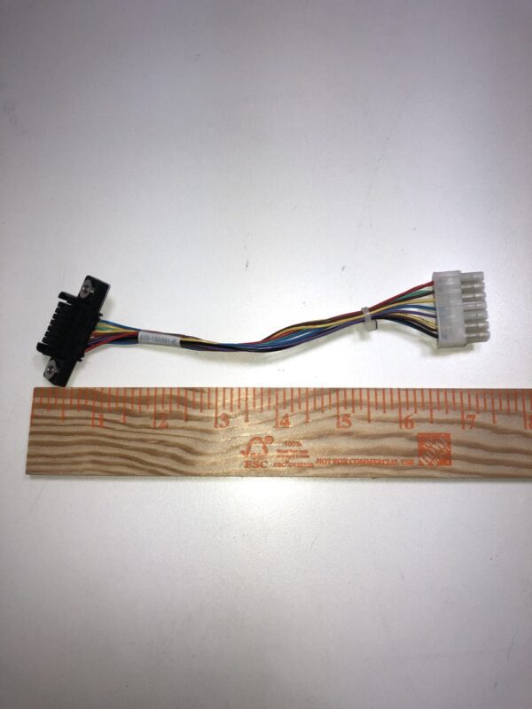 A ruler with a JCM Cable for WBA and UBA Bill acceptor attached to it.