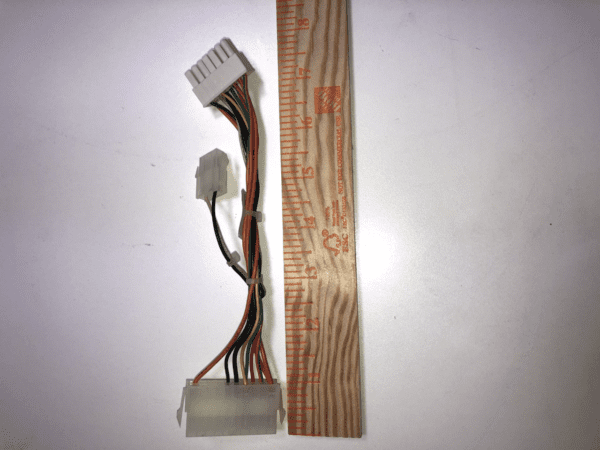 A JCM Cable for WBA and UBA Bill acceptor with a ruler next to it.