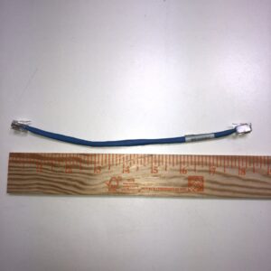 A blue JCM Cable for WBA and UBA Bill acceptor with a ruler next to it.