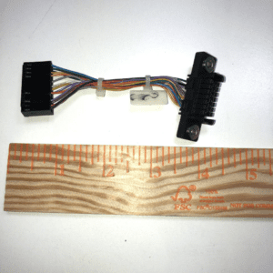 A ruler with a JCM Cable for WBA and UBA Bill acceptor attached to it.