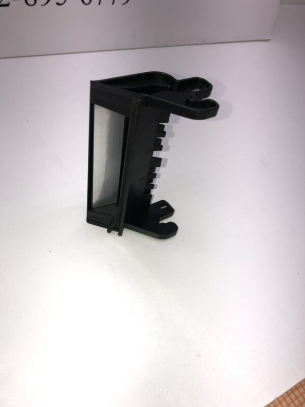 A Bill Validator Bezel for MEI BV Unit, New Part, Black Plastic, sitting on top of a table.