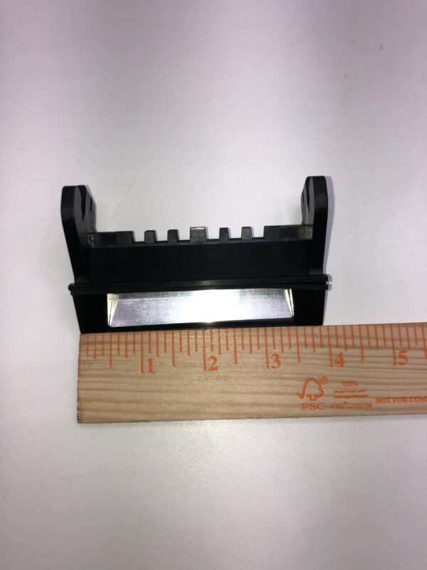 A ruler with the Bill Validator Bezel for MEI BV Unit attached to it.