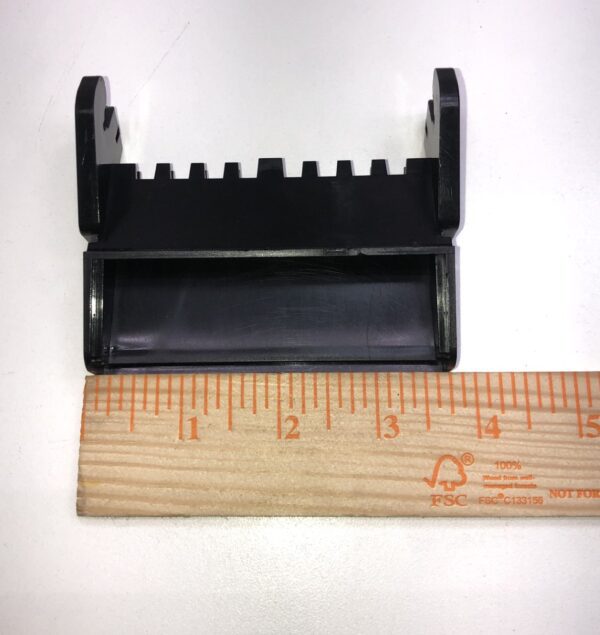 A Bill Validator Bezel for MEI BV Unit, new part, black plastic holder next to a ruler.