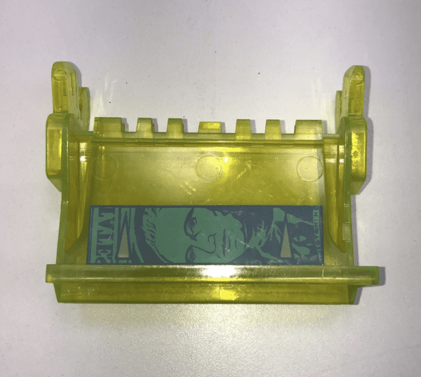 A yellow plastic Bill Validator Bezel, MEI "President Face" holder with a picture on it.