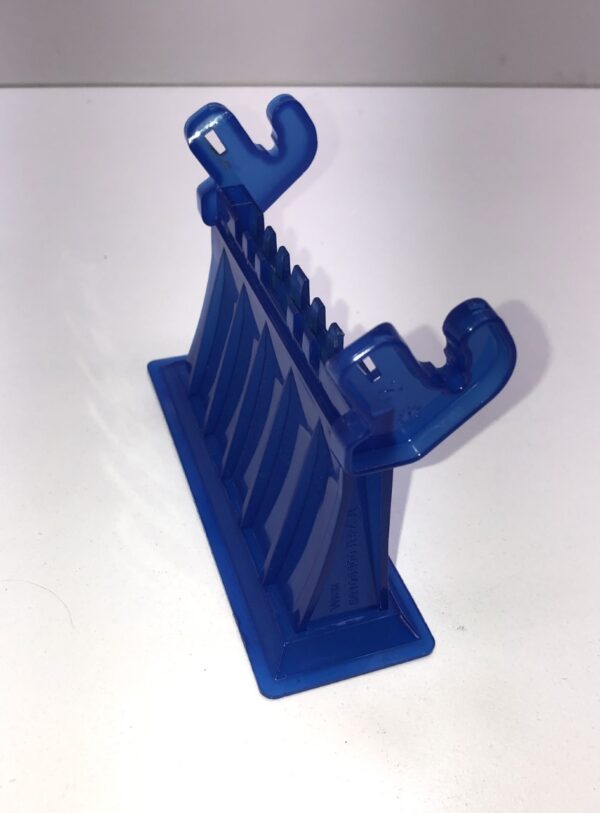 A blue plastic Bill Validator Bezel for MEI BV Unit holder on a white surface.