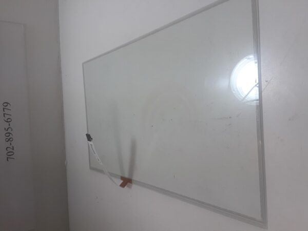 A 21.78".TPK Touch Sensor on the wall of a room.