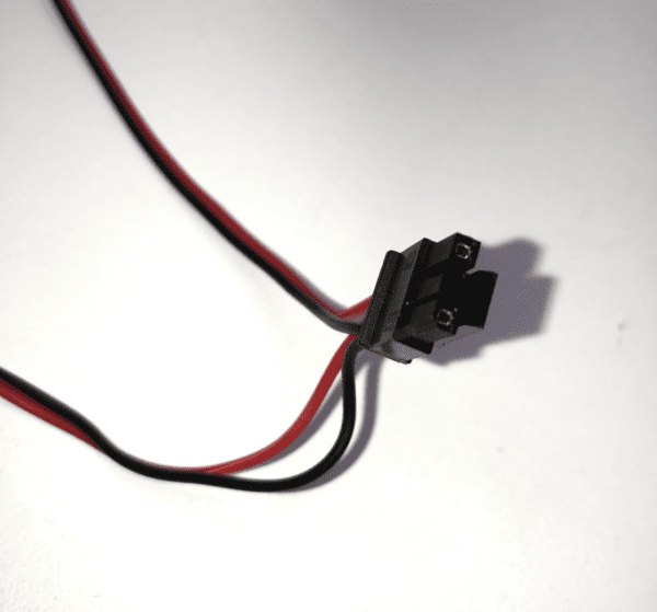A black and red wire is attached to a white surface of the 24v Dual LED Board for Bally 6000+9000 Validator. GETT Part LED Board 100.