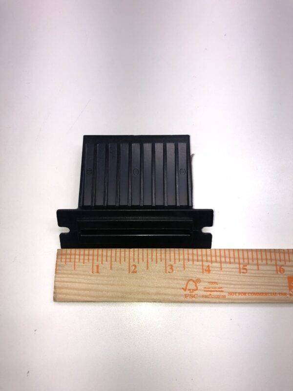 A small Ticket Bezel, Black, Plastic, See pics. Fits WMS Games, Others., with a ruler next to it.