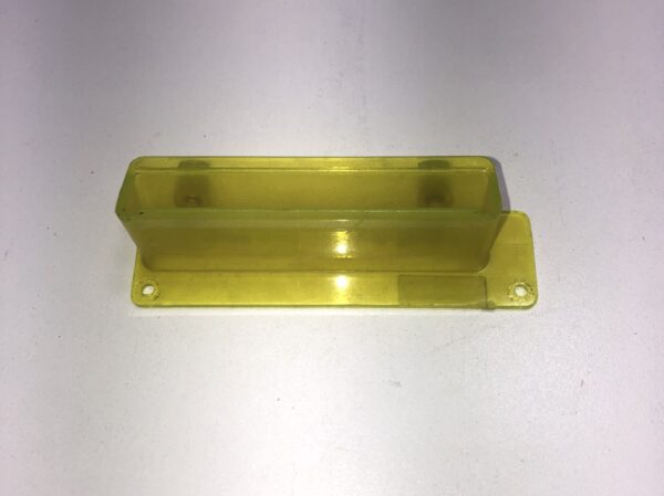 A Ticket Printer Bezel, yellow plastic box on a white surface.