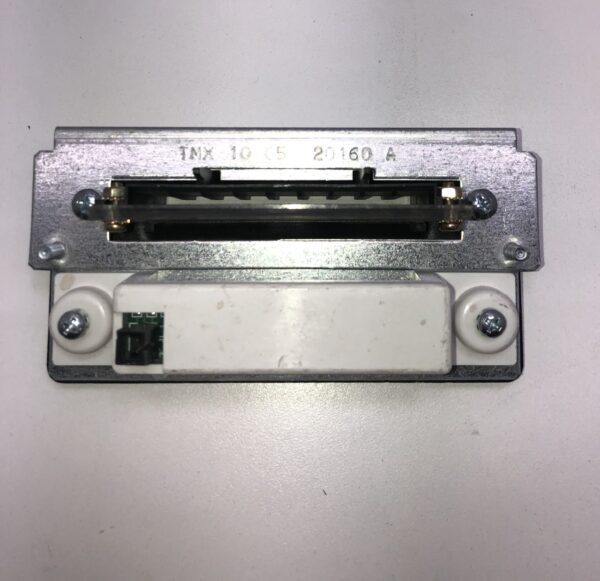 A small piece of Ticket Printer Bezel, Fits IGT Games, attached to a white surface.