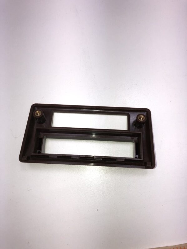 A brown Ticket Printer Bezel, Black/ Plastic holder on a table.