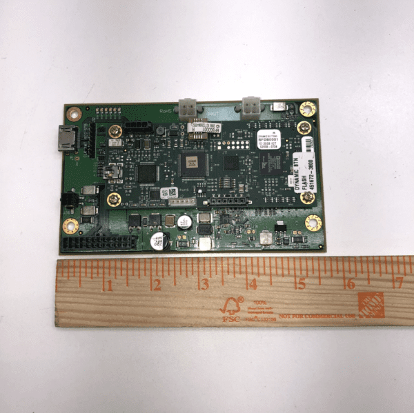 A small IGT AVP Dynamic Button Board next to a ruler.
