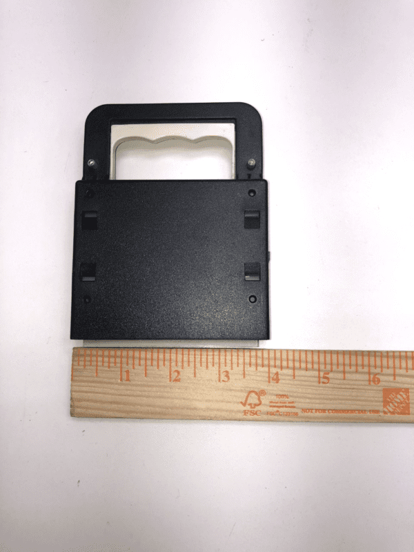 A black plastic IGT Universal I/U Card IGT P/N 14940201W. GETT Part IOB110 case with a ruler next to it.
