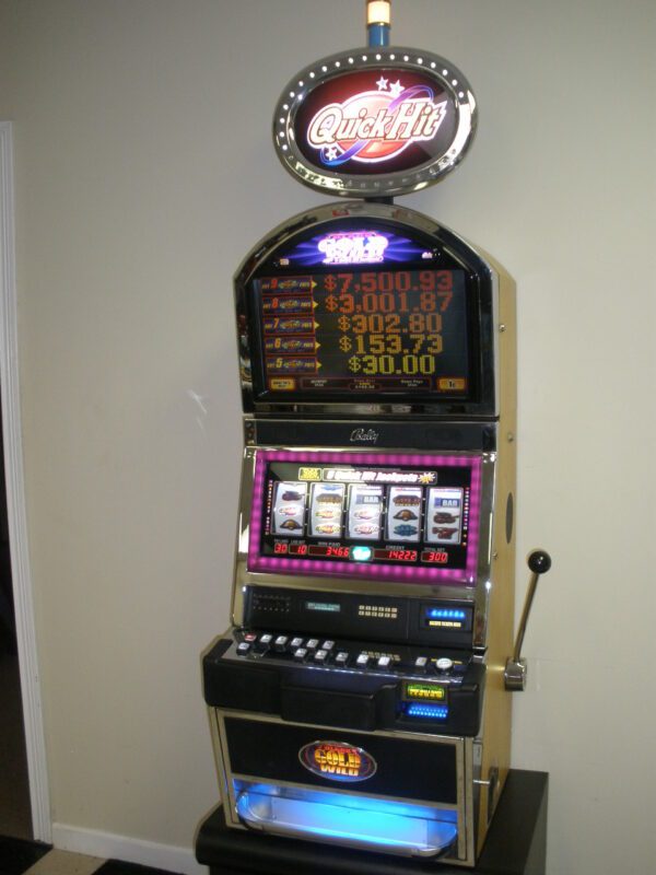 A slot machine with a sign on it.