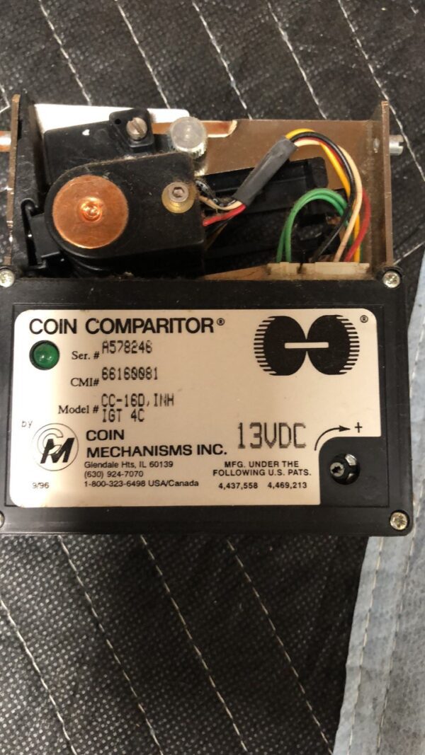 A Coin Mech Coin Comparitor for IGT Games. Part # CC-16D,INH IGT 4C. GETT Part CoinComp100 is sitting on top of a table.
