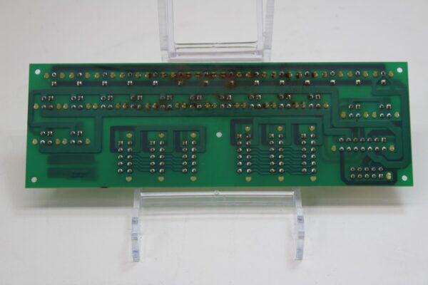 A green IGT Game King, I-960 CABINET NETPLEX DISTRIBUTION board on a clear stand.