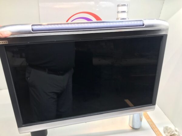 A person is standing next to a WMS BBxD MetaScreen LCD Top Box Kit with a screen on it.