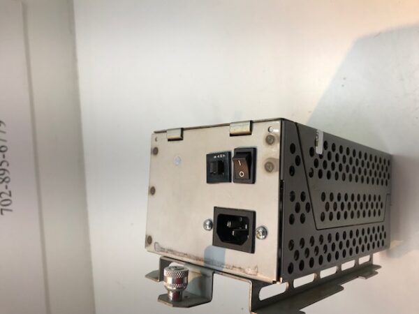 A small IGT SAVP and Trim Line Power Distribution Unit sitting on top of a wall.