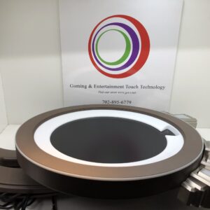 A circular table with a Bally Wave Topper WHEEL with Large LCD on top of it.