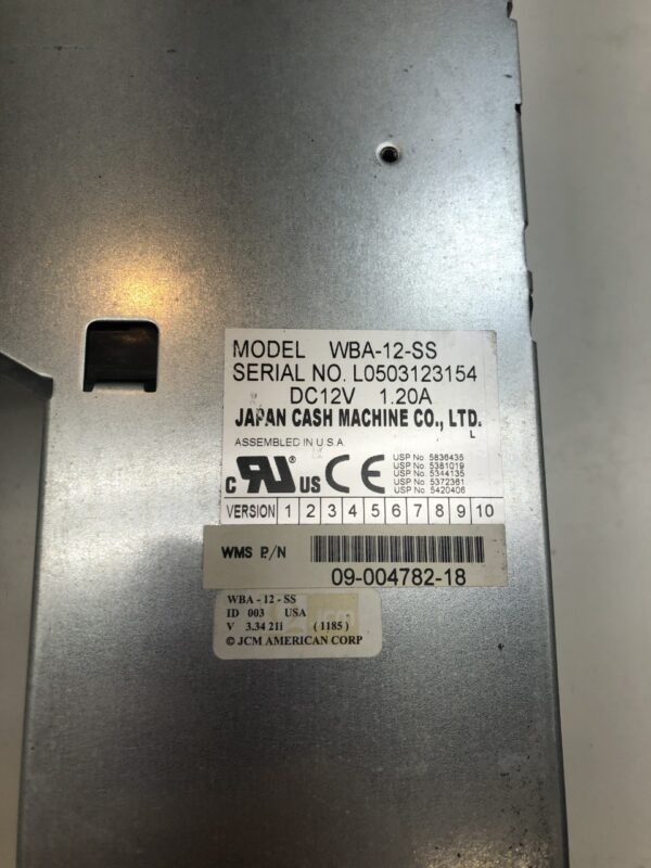 A JCM WBA Head & Transport machine with a label on it.