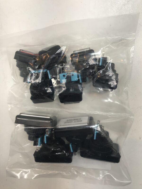 A set of black and blue plastic parts in a plastic bag containing the New Button Kit- Fits IGT Game King and I960 games. Small Square Push Button Set (10pcs) GETT Part BTN107.