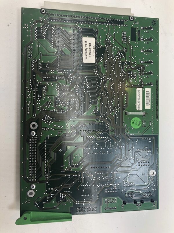 A green Atronic E-Motion Comm' Board on a white surface.