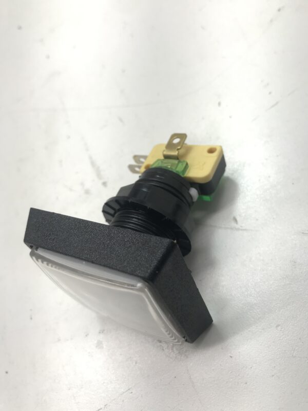 A black and green Gamesman Buttons- 570 Series. 2 inch button length. GETT Part BTN142 light switch on a white surface.