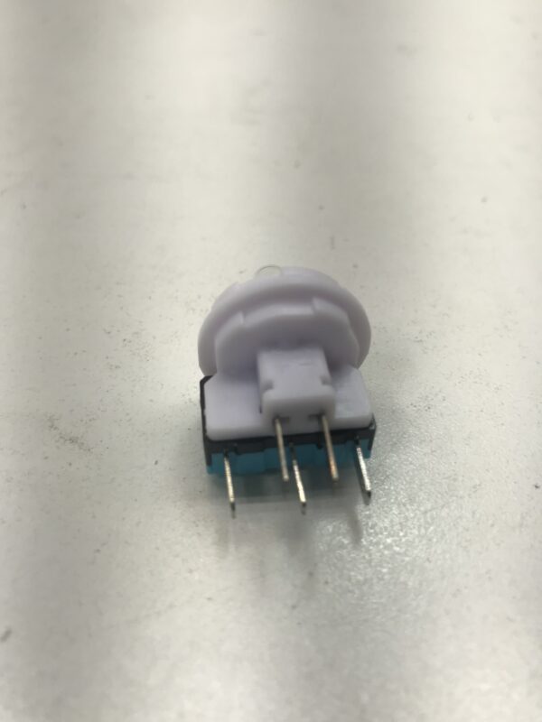 A small white Button Lamp holder, fuse and lamp assembly with a light blue switch on top of a table.