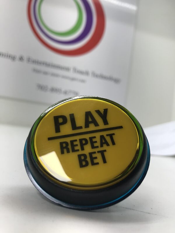 A Incredible Technologies 2.5 inch diameter Yellow Spin Button that says play repeat bet. GETT Part BTN174.