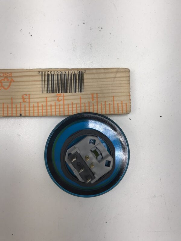 A blue Incredible Technologies 2.5 inch diameter Yellow Spin Button with a ruler next to it. GETT Part BTN174.