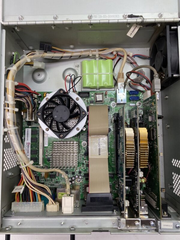 The inside of a Spielo CPU, Complete computer case with a fan and other electronics.