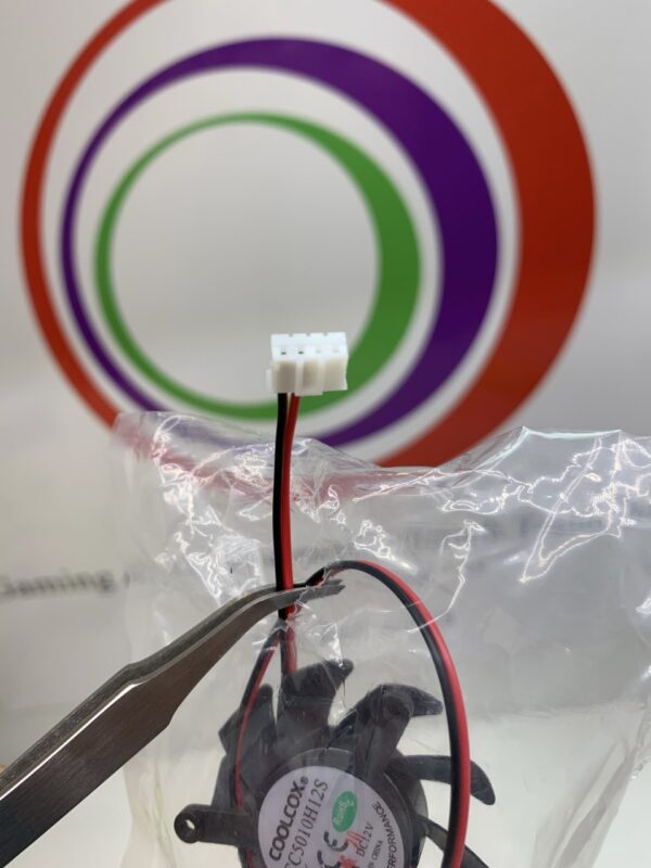 A Cooling Fan is being used to remove a wire from a plastic bag.