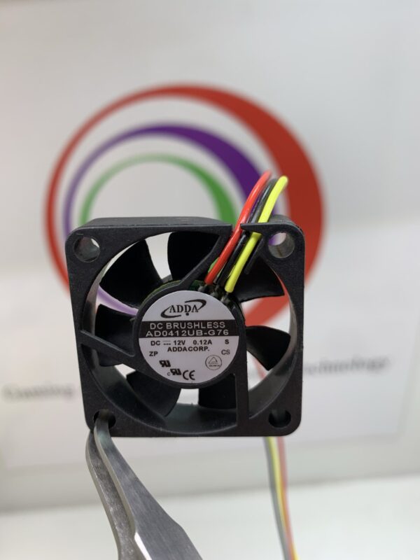 A ADDA Brand Cooling Fan ADDA Part AD0412UB-G76 12VDC x .12A. 3 Wire w/connector 1 ½”x 3/8” with a wire attached to it.