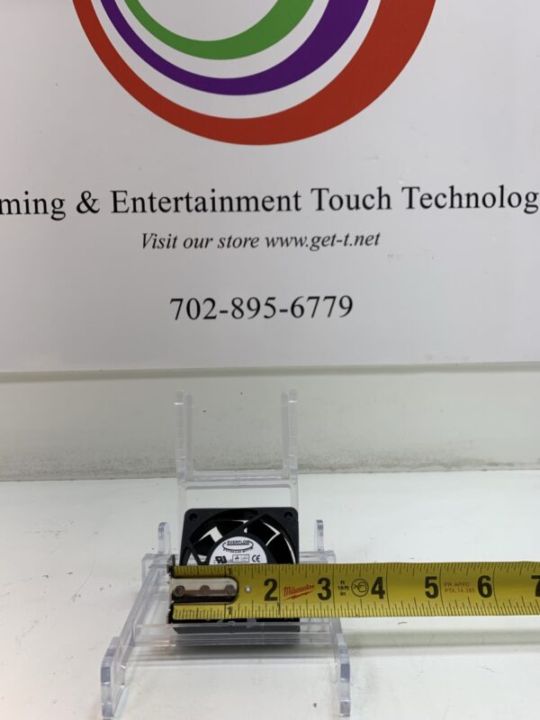 A Cooling Fan next to a sign that says entertainment & touch technology.