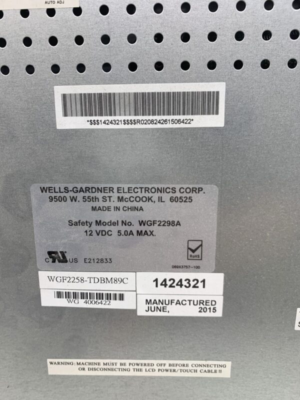 The back of a 22" Wells Gardner LCD Touch Monitor with a label on it.