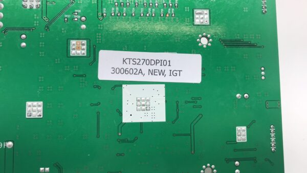 A green ADB 27" pcb with a label on it.