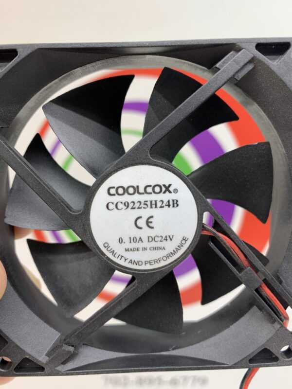 A CoolCox Cooling Fan- Part # CC9225H24B, 24V x.10A  3 WIRE NO CONNECTOR. GETT Part Fan126 is being held in a person's hand.