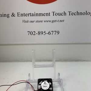 A Cooling Fan- Delta Brand- Part # EFB0412HHA sits on a table next to a sign that says learning & entertainment touch technology.