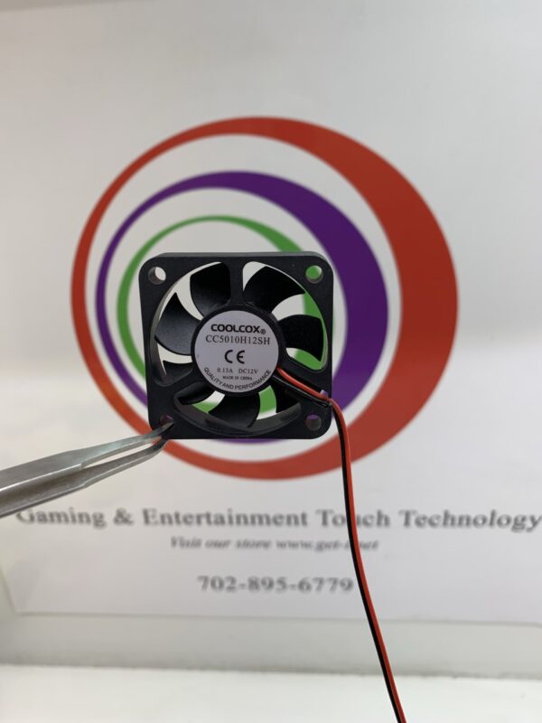 A small Cooling Fan, 12VDC x.13A,CoolCox brand- Part # CC5010H12SH with a wire attached to it.