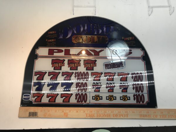 A slot machine with an IGT Double Diamond Belly Glass, 20.25" x 9.5", and GETT Part BellyGlass100 on it.