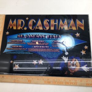 A Top Glass for Aristocrat Mark 5 games, Mr Cashman poster on a ruler.